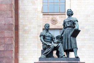 Statue of man and women in front of main building of Lomonosov Moscow State University, Russia